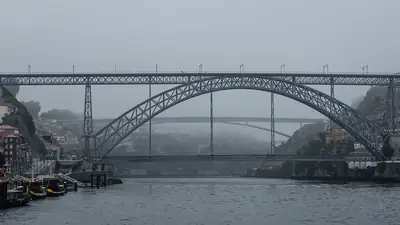 A ponte Luís I, no Porto, envolta em nevoeiro sobre o rio Douro